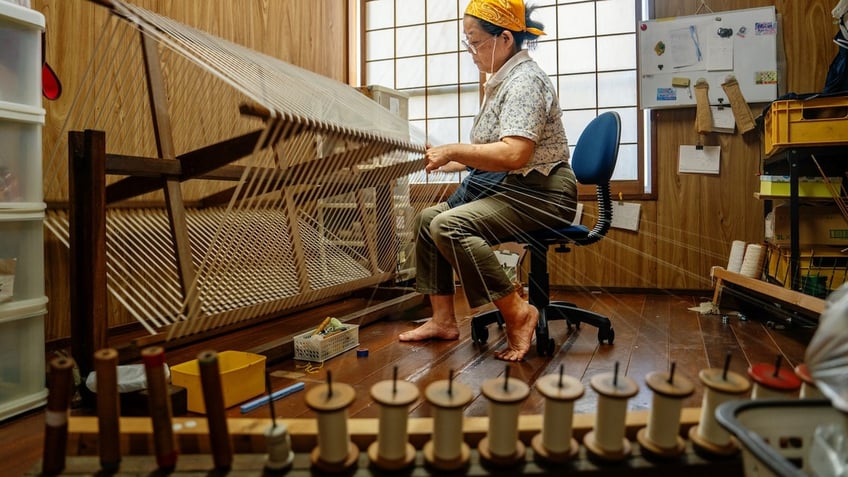 Elderly woman sewing