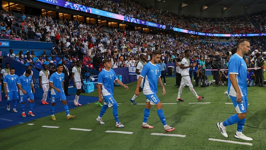 Israel players walk on the field