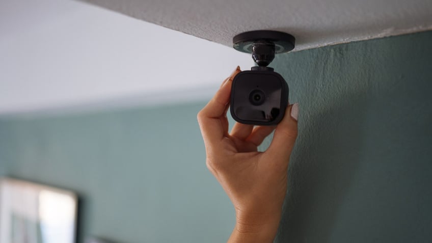 A person installing a security camera