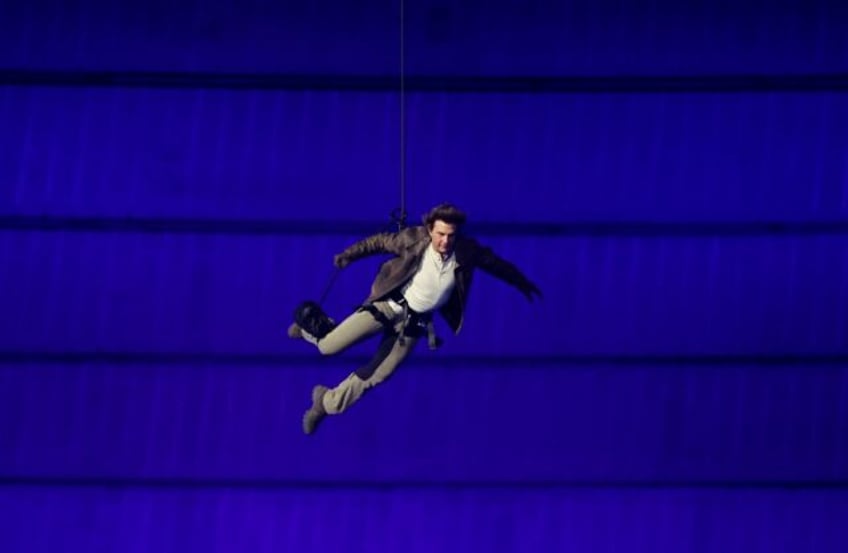 Hollywood star Tom Cruise descended from the roof of the Stade de France on a wire during