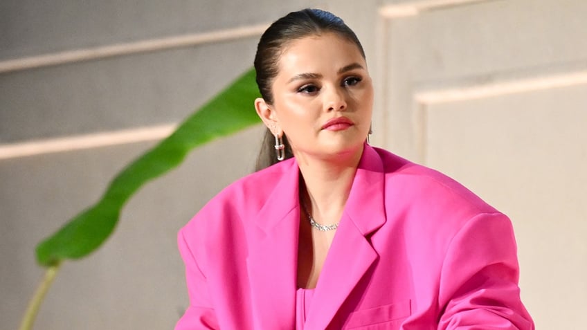 Selena Gomez wears a pink suit