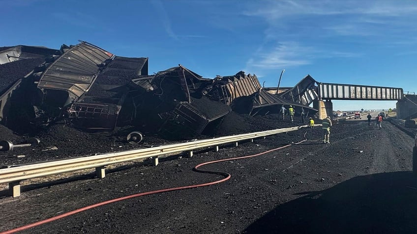 semitruck driver dies in colorado after train derails spilling cars and coal onto highway