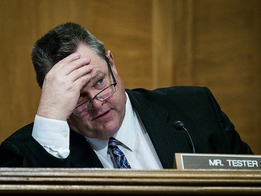 WASHINGTON, DC - JANUARY 30: Senator Jon Tester (D-MT) looks on as Treasury Secretary Steven Mnuchin delivers the annual financial stability report to the Senate Banking, Housing and Urban Affairs Committee on January 30, 2018 in Washington, DC. Mnuchin said the Treasury can extend the government's debt limit suspension period …