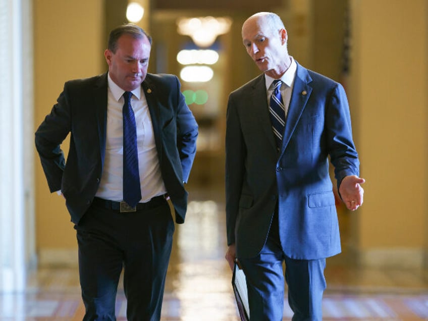 Sen. Mike Lee, R-Utah, left, and Sen. Rick Scott, R-Fla., leave a meeting in the office of