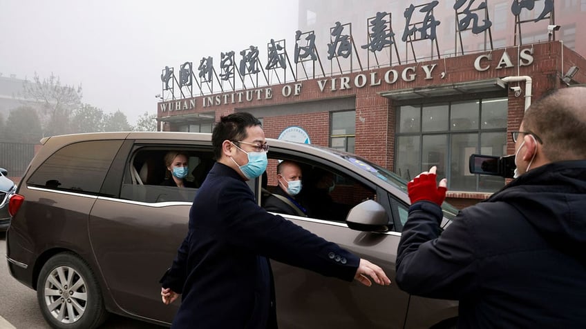 Peter Daszak and Thea Fischer, members of the World Health Organization (WHO) team tasked with investigating the origins of the coronavirus disease (COVID-19), sit in a car arriving at Wuhan Institute of Virology in Wuhan, Hubei province, China February 3, 2021. REUTERS/Thomas Peter