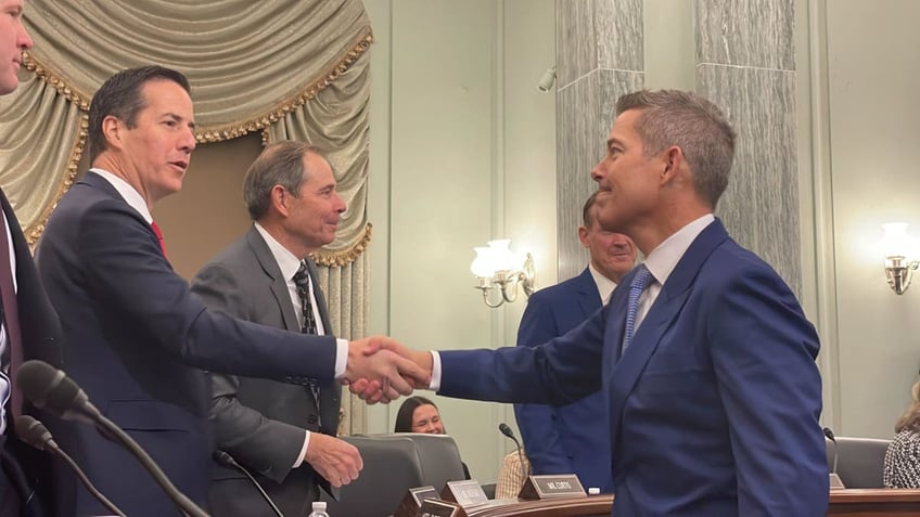 Sean Duffy, right, greets senators at his confirmation hearing.