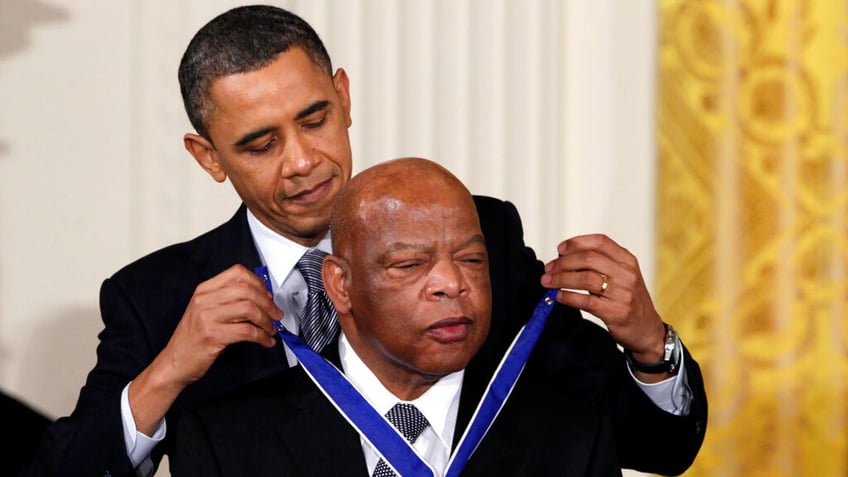 In this Feb. 15, 2011, file photo, President Obama presents a 2010 Presidential Medal of Freedom to U.S. Rep. John Lewis, D-Ga.  (AP Photo/Carolyn Kaster, File)