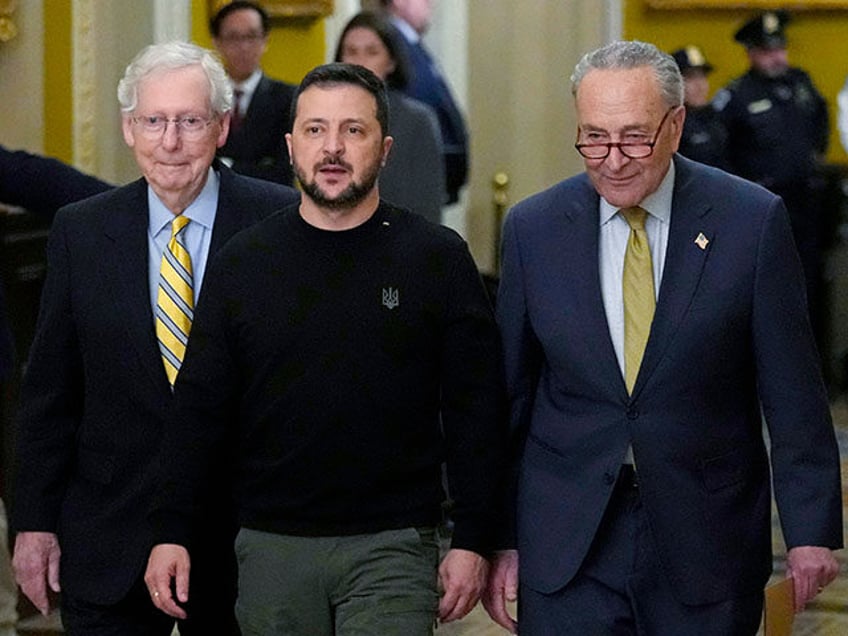 Ukrainian President Volodymyr Zelenskyy, center, walks with Senate Minority Leader Mitch M