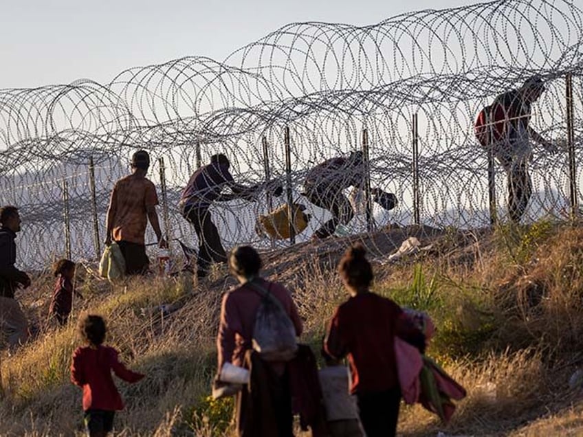 Immigrants cross into the United States from Mexico hoping to be processed by U.S. border