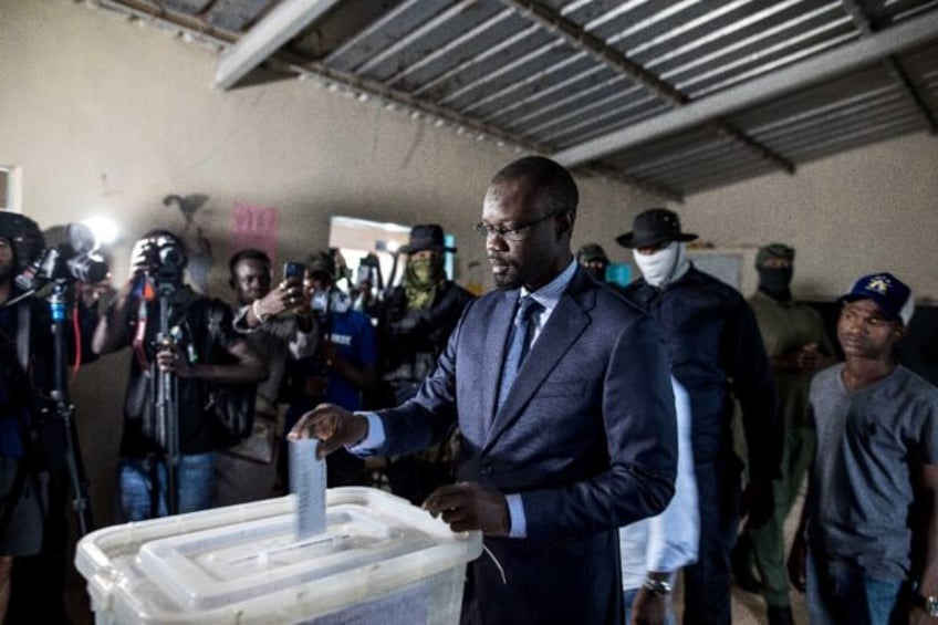 Jailed Senegalese opposition figure Ousmane Sonko (C) finished third in the 2019 presidential election