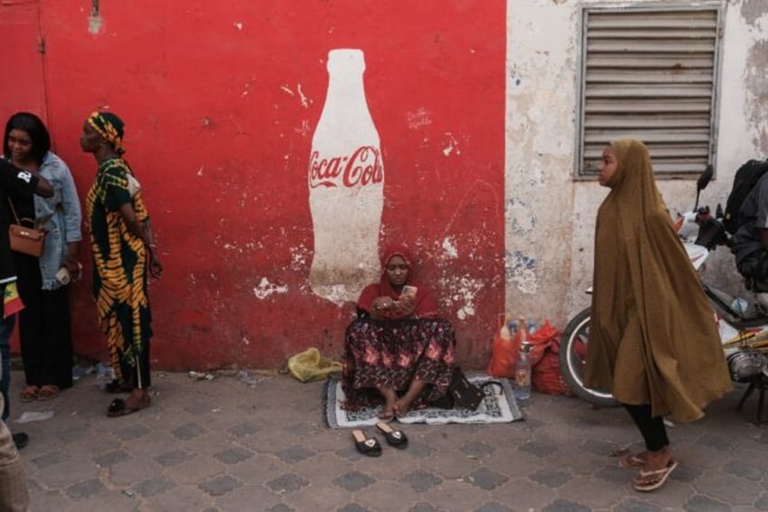 Outside Dakar's Rebeuss prison, relatives, friends and curious onlookers waited for more