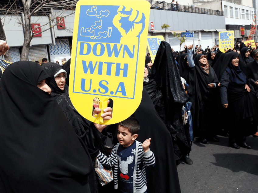 Iranians chant slogans during an anti-US rally following Friday prayers in Tehran on April