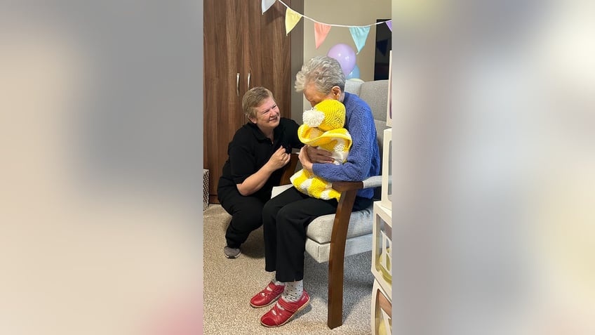 seniors with dementia are treated to baby shower with dolls to help relieve stress sense of purpose