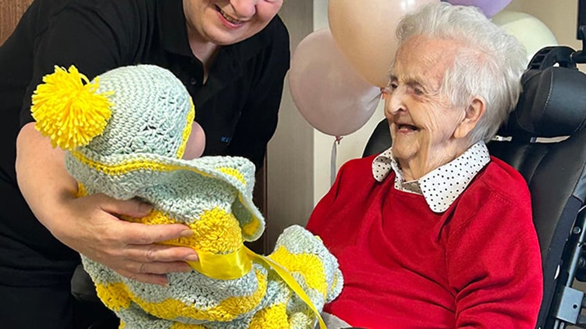 seniors with dementia are treated to baby shower with dolls to help relieve stress sense of purpose