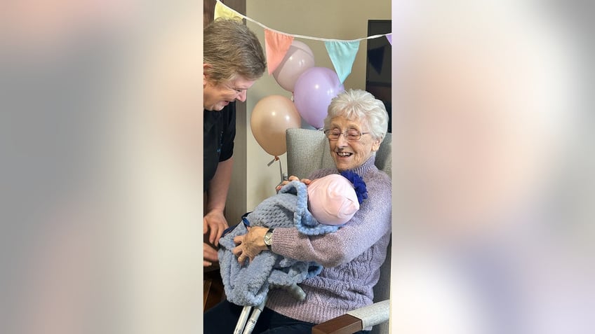 seniors with dementia are treated to baby shower with dolls to help relieve stress sense of purpose