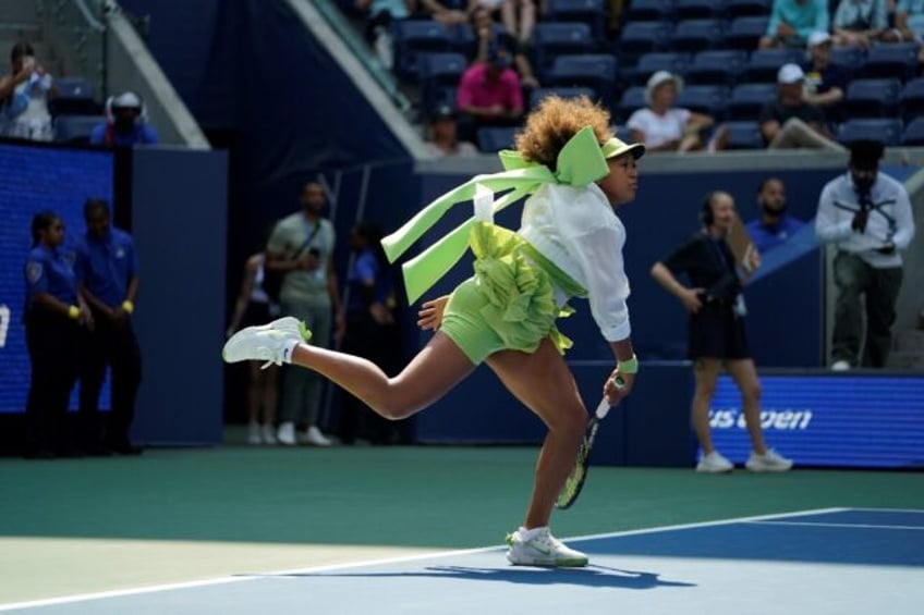 Green day: Naomi Osaka warms up before her match against Jelena Ostapenko at the US Open o