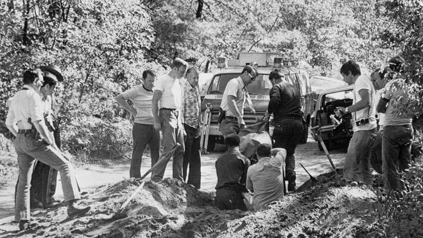 State police removing a body from a ditch.