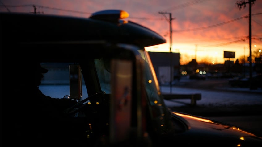 Truck driver sits in truck cab