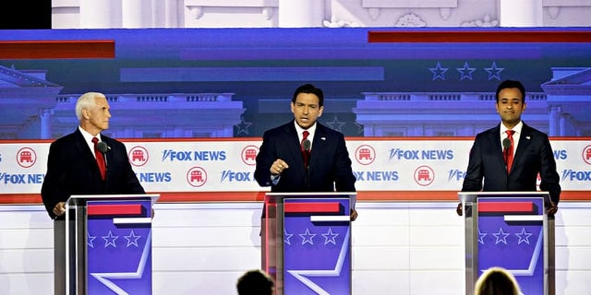 seven of eight republican candidates raise hands to say theyd support trump as nominee even if convicted