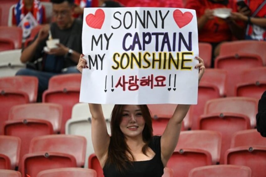 A fan of Son Heung-min holds up a sign before the 2026 FIFA World Cup AFC qualifier betwee