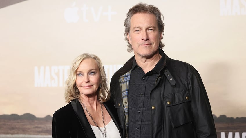 Bo Derek and John Corbett posing together