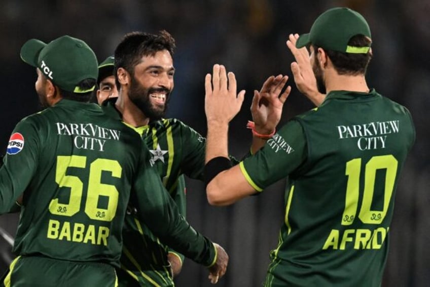 Back in business: Mohammad Amir (2L) celebrates after taking the wicket of New Zealand's D