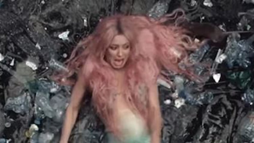 shakira freaks out as rat creeps toward her head while she lies on rocky beach for glamorous music video