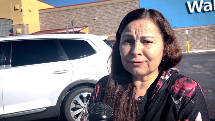 Woman stands in parking lot