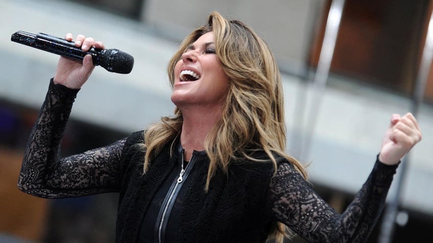 Shania Twain singing into microphone