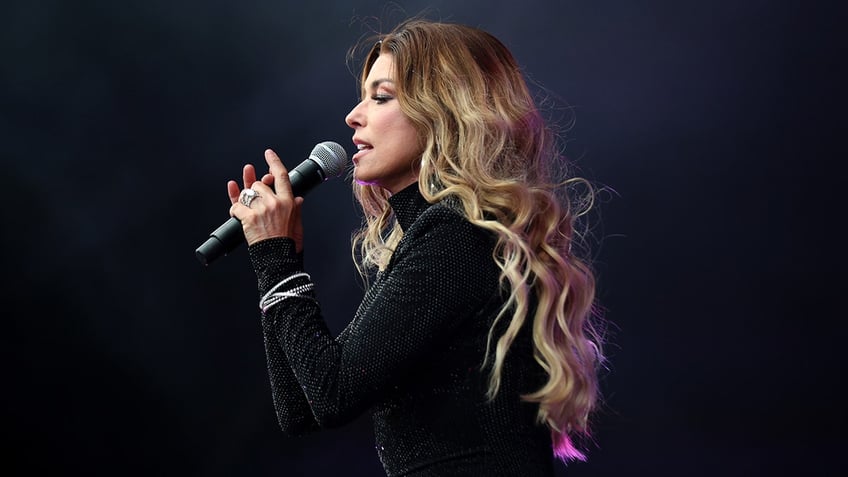 Shania Twain singing into microphone