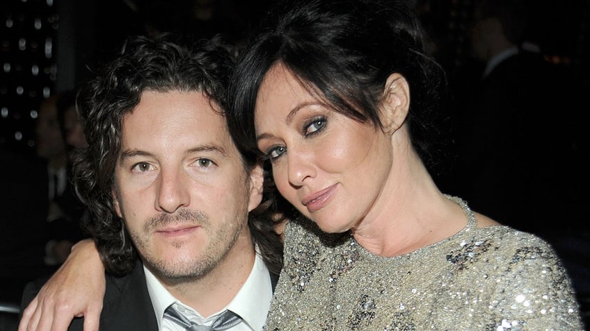 Shannen Doherty wraps her arms around husband Kurt Iswarienko.