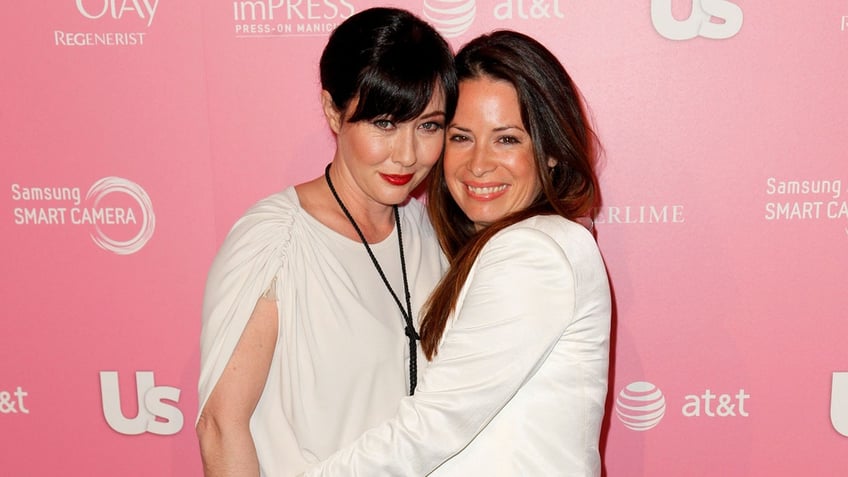 Holly Marie Combs and Shannen Doherty in white on the red carpet.