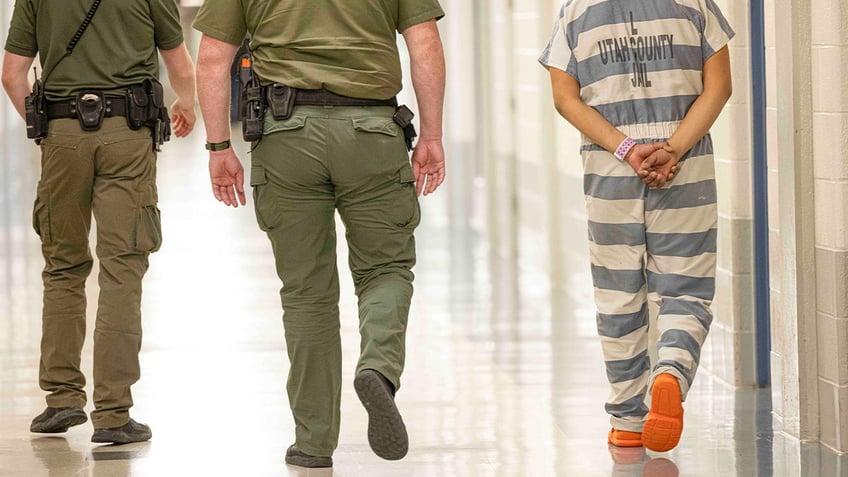 Utah County Jail inmate escorted down hallway