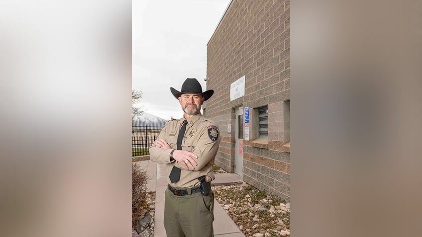 Sheriff Mike Smith stands outside with arms crossed