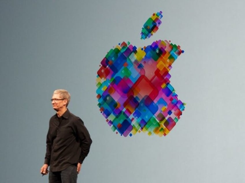 Tim Cook in front of Apple logo