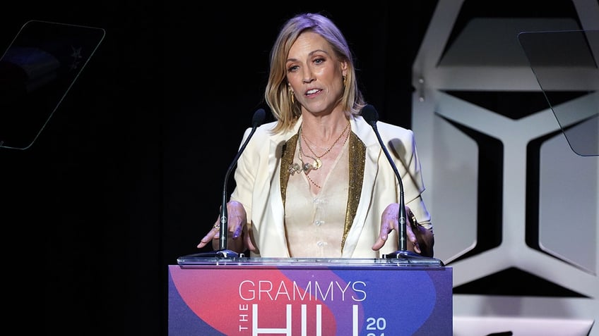 Sheryl Crow standing at a podium