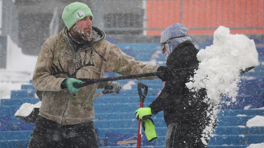 Workers remove snow