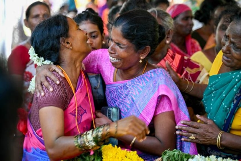 Relatives mourn those who died after drinking toxic alcohol in India's Tamil Nadu state on