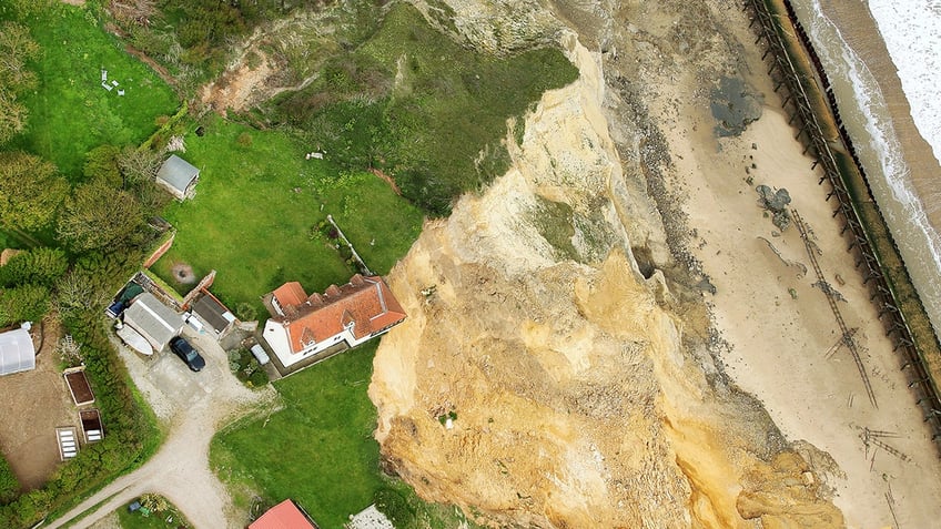 farmhouse hanging over cliff edge SWNS