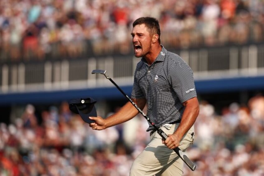 American Bryson DeChambeau reacts after sinking the winning putt at the 18th hole to captu