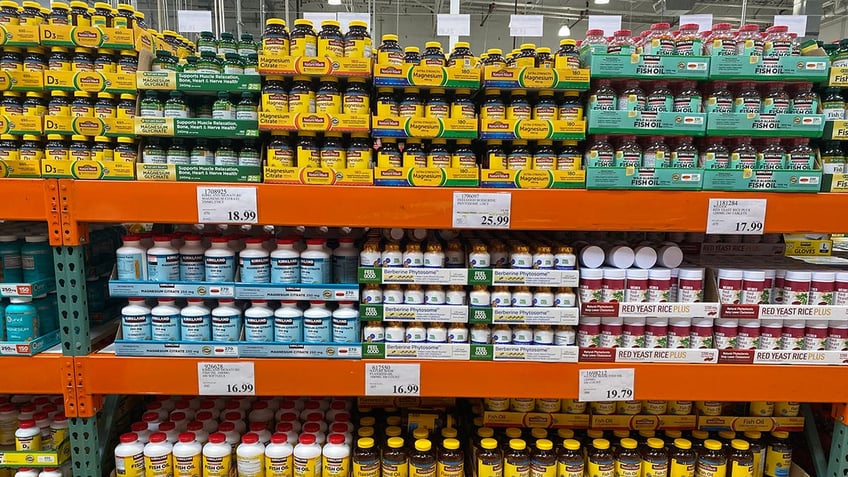 Rows of fish oil supplement bottles seen at wholesale store.