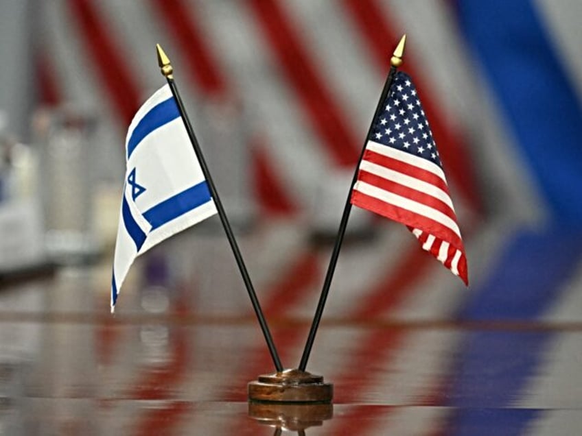 Israeli and US flags are seen on the table as US Secretary of Defense Pete Hegseth meets w
