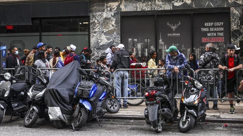 Roosevelt Hotel with migrants lined up outside