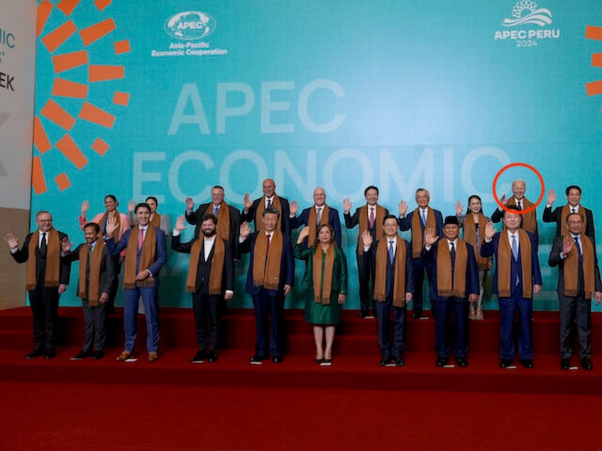 President Joe Biden stands in the back row, 2nd-right, with other APEC leaders as they pos