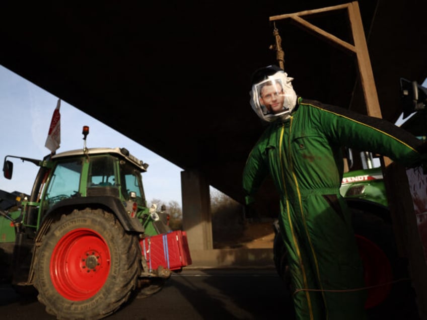 A mannequin in the effigy of French President Emmanuel Macron hangs next to tractors during a road blockage of the A6 highway near Villabe, south of Paris, on January 29, 2024, amid nationwide protests called by several farmers unions on pay, tax and regulations. Local branches of major farmer unions …