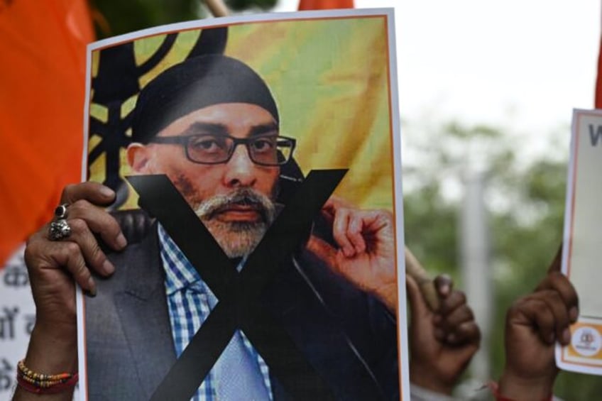 A member of United Hindu Front organisation, at a New Delhi rally, holds a banner depictin