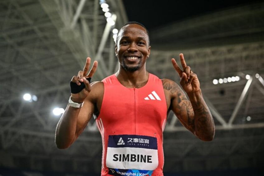South Africa's Akani Simbine celebrates after winning the men's 100m
