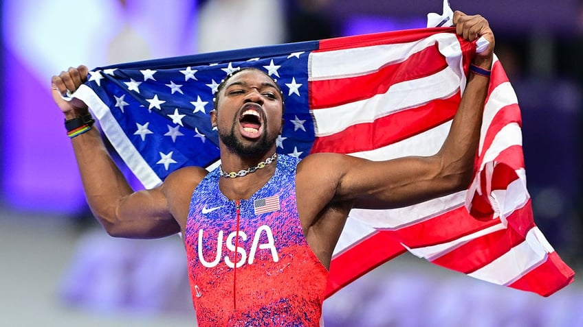 Noah Lyles with the American flag