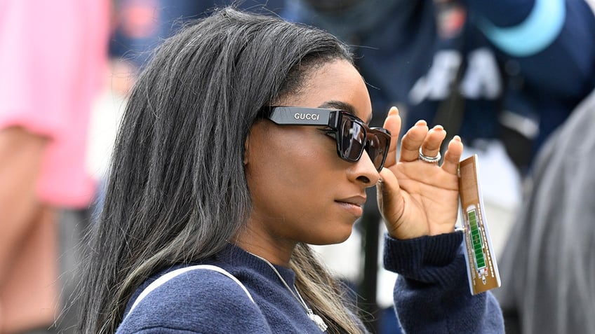 Simone Biles walks on field