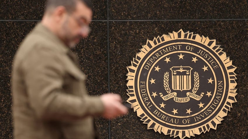 A man walks past a DOJ building